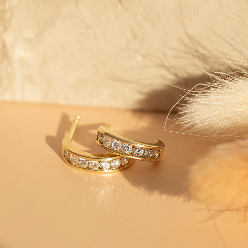 14 karat yellow gold half-hoop earrings with zirconia