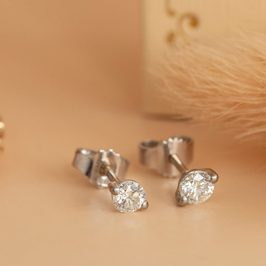 18 karat white gold solitaire diamond stud earrings