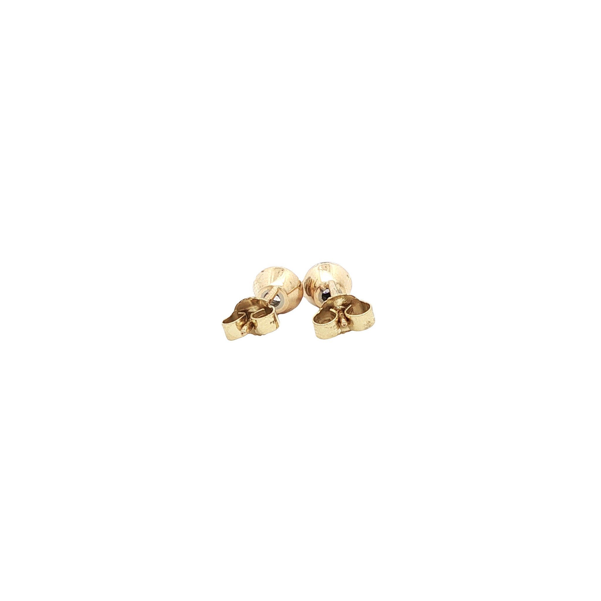 Solitaire diamond stud earrings in 14 karat gold.