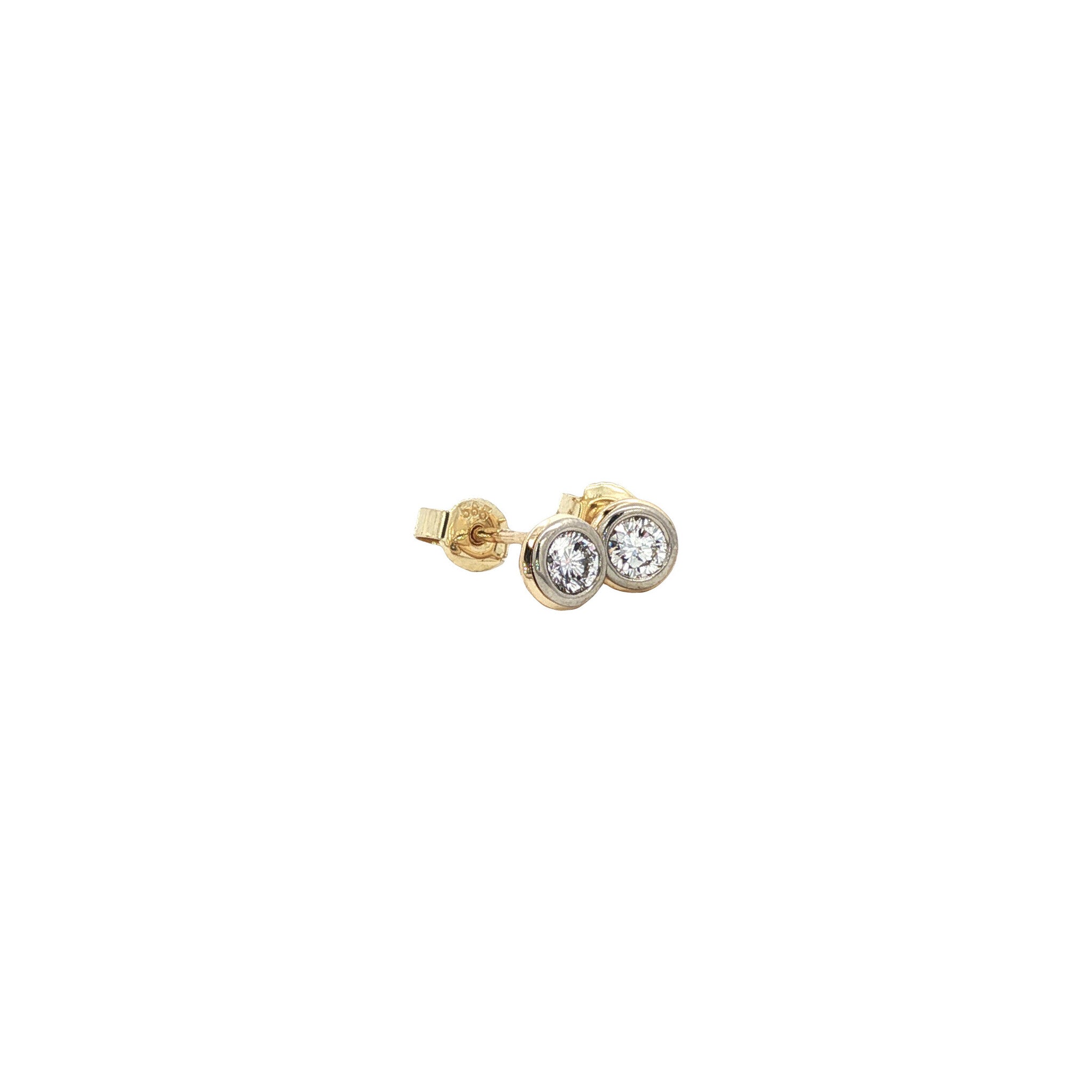 Solitaire diamond stud earrings in 14 karat gold.